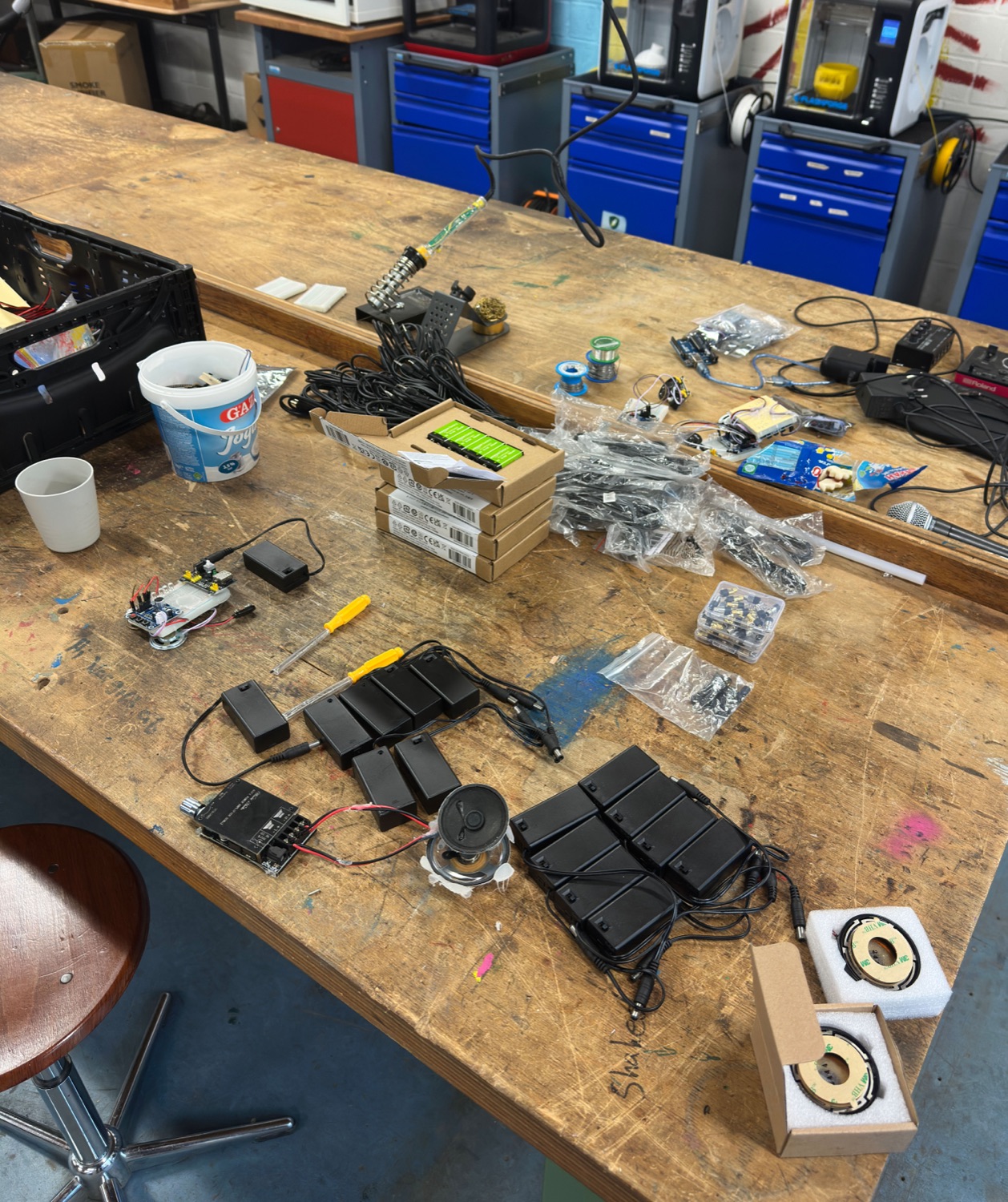 A workbench with components prepared for the next workshop