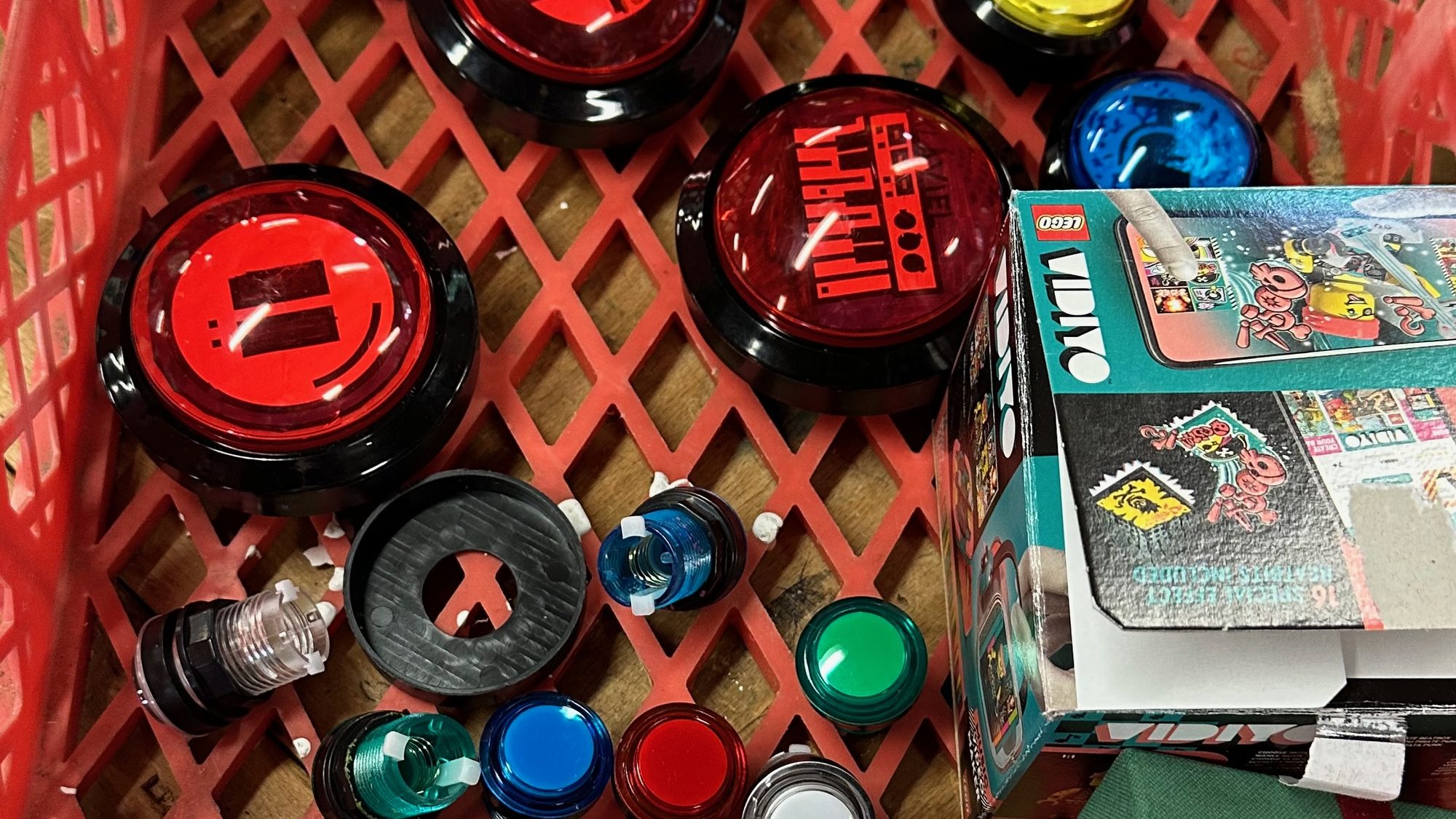 A crate full of arcade buttons: the raw material of the first workshop